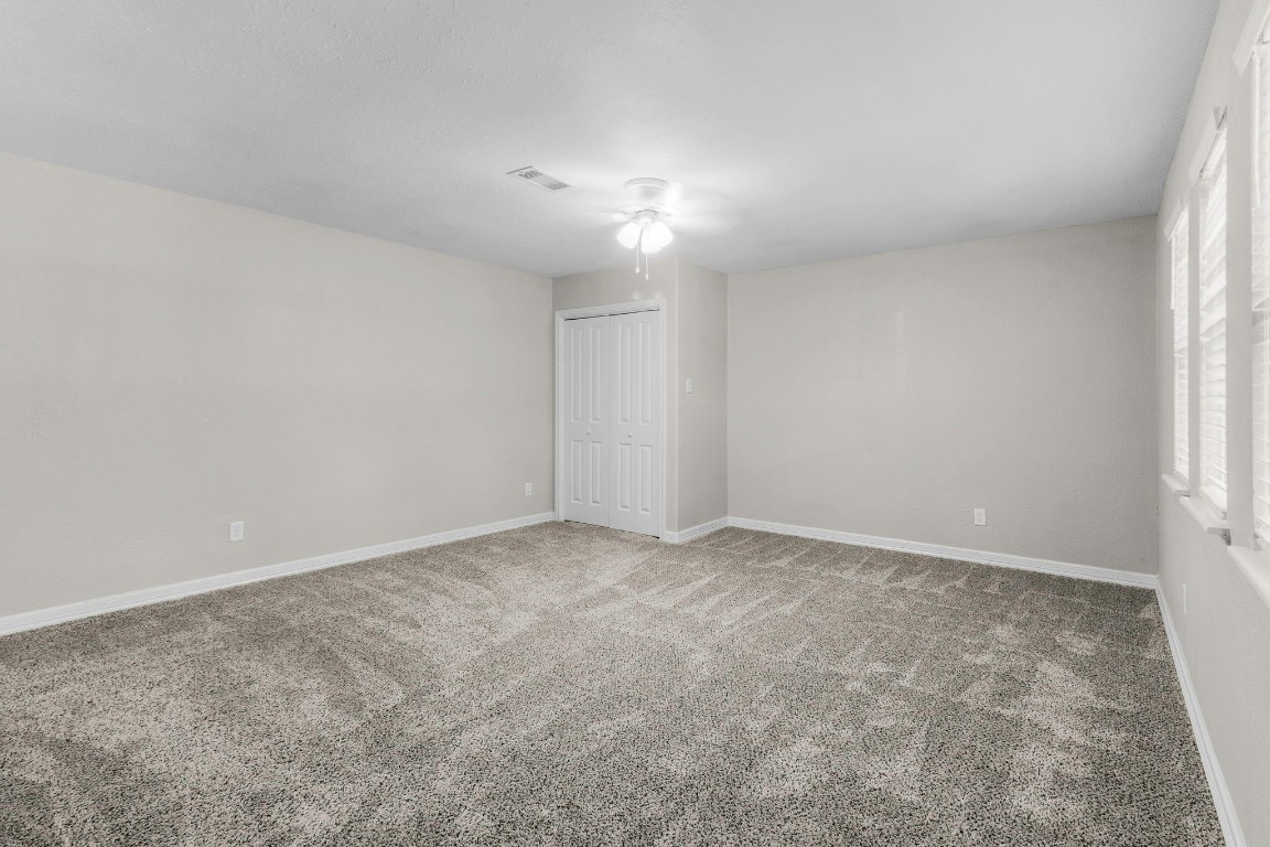 21 Red Oak Circle Point Blank, TX 77364 - Photo 11 of 50 an empty room with a empty space and a window