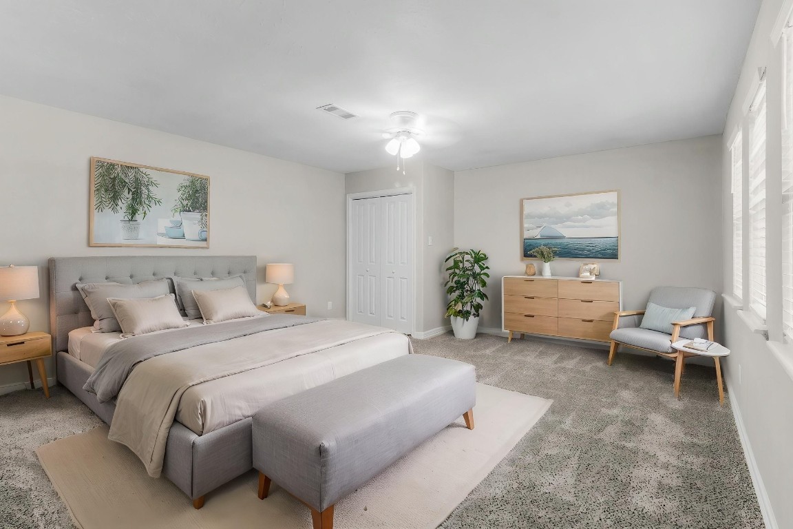 21 Red Oak Circle Point Blank, TX 77364 - Photo 12 of 50 a spacious bedroom with a bed a couch and paintings on the wall