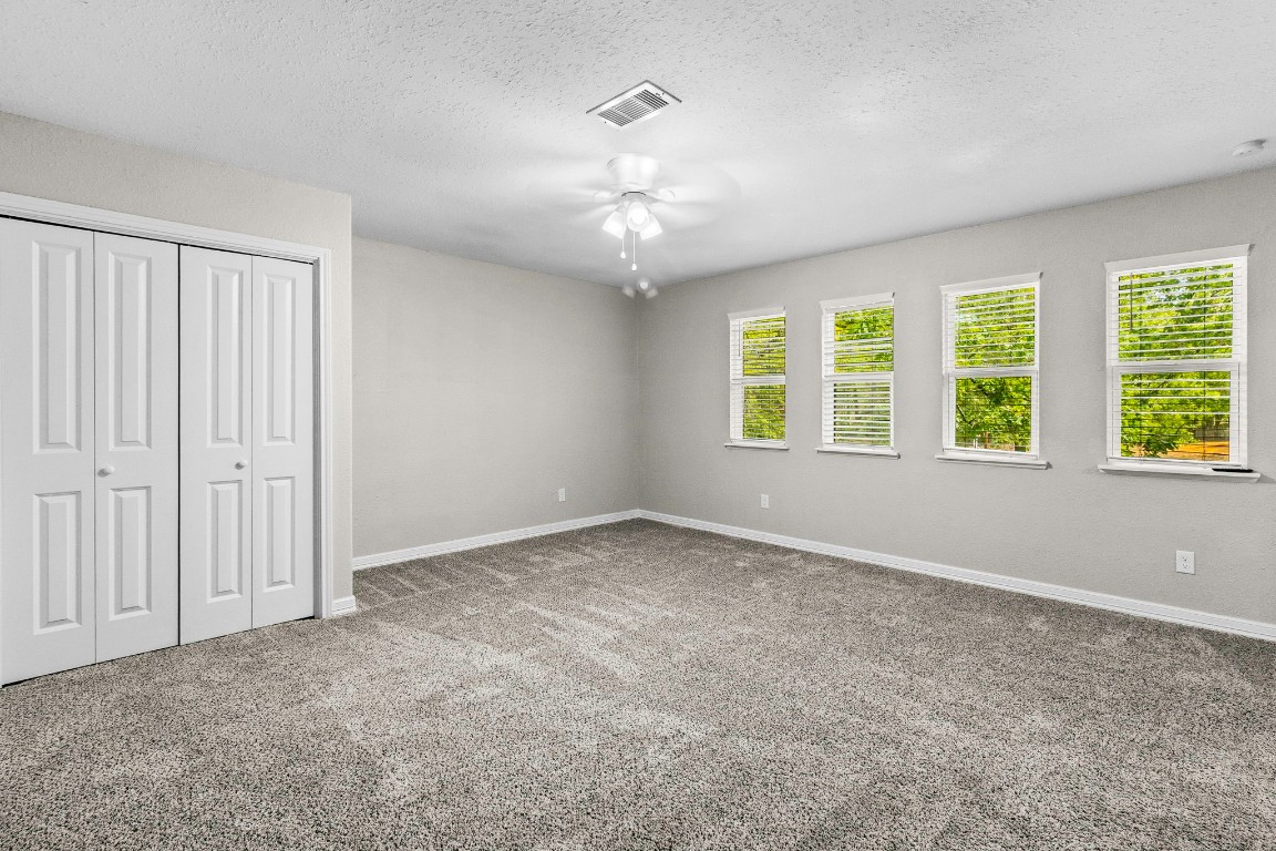 21 Red Oak Circle Point Blank, TX 77364 - Photo 13 of 50 an empty room with windows and chandelier fan