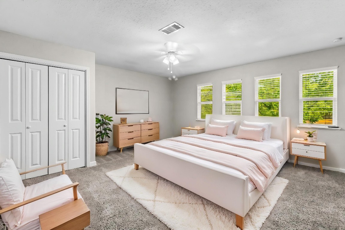 21 Red Oak Circle Point Blank, TX 77364 - Photo 14 of 50 a spacious bedroom with a bed a chandelier and a window