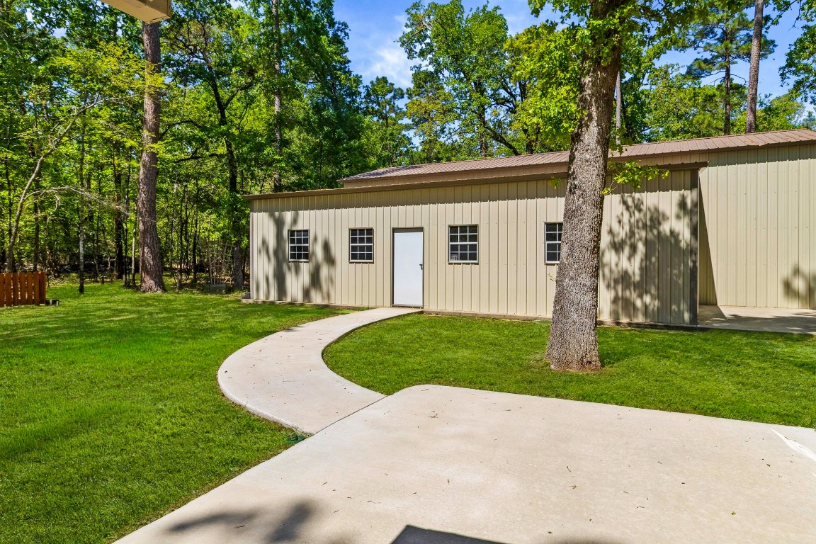 21 Red Oak Circle Point Blank, TX 77364 - Photo 35 of 50 a front view of a house with a yard