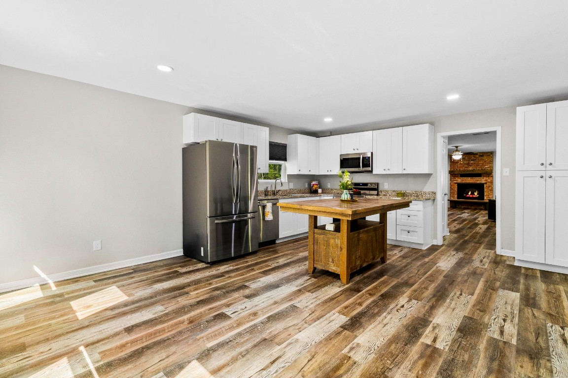 21 Red Oak Circle Point Blank, TX 77364 - Photo 6 of 50 a kitchen with stainless steel appliances a refrigerator and a stove top oven