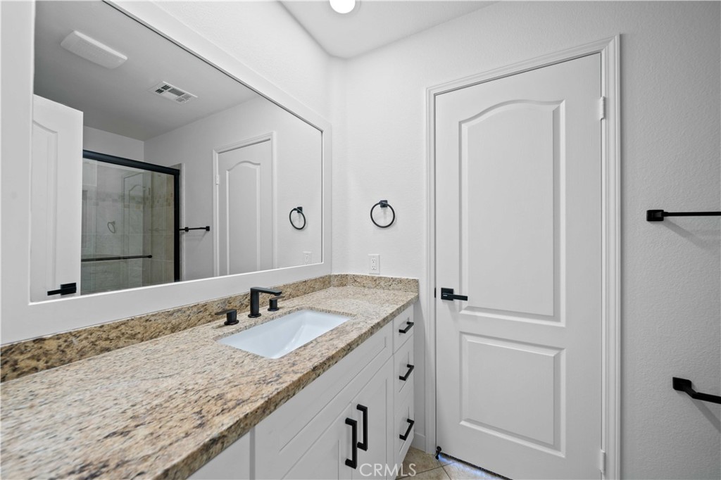 22 Oak Tree Drive Rancho Mirage, CA 92270 - Photo 13 of 25 a bathroom with a granite countertop sink and a mirror