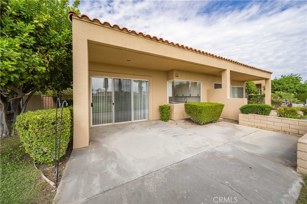 22 Oak Tree Drive Rancho Mirage, CA 92270 - Photo 19 of 25 a view of a house with a backyard and a garden
