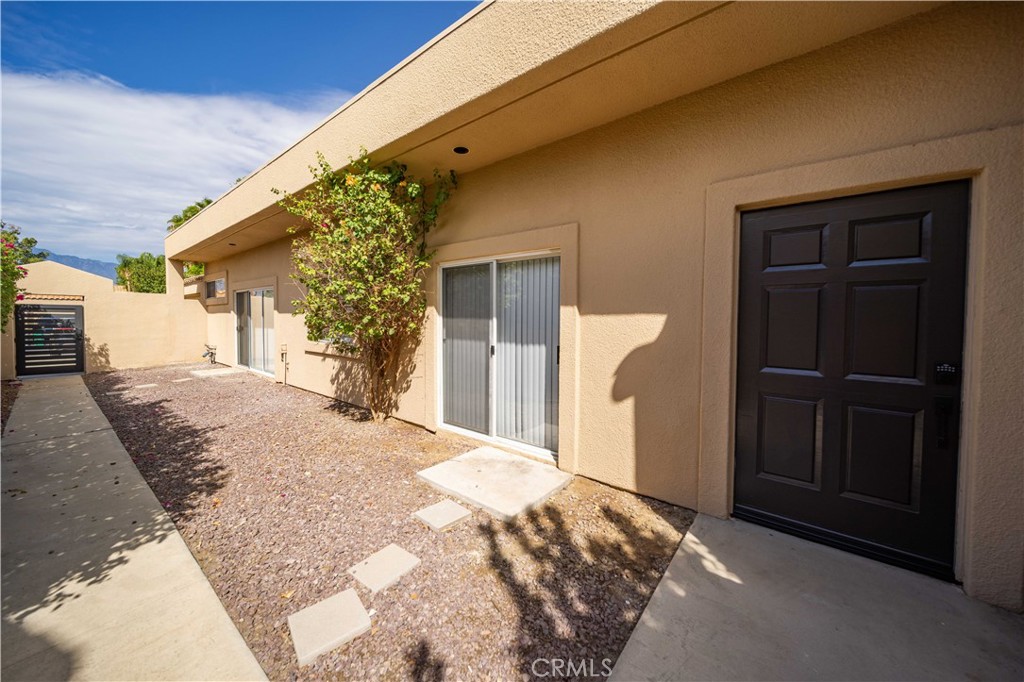 22 Oak Tree Drive Rancho Mirage, CA 92270 - Photo 21 of 25 a front view of a house with a yard
