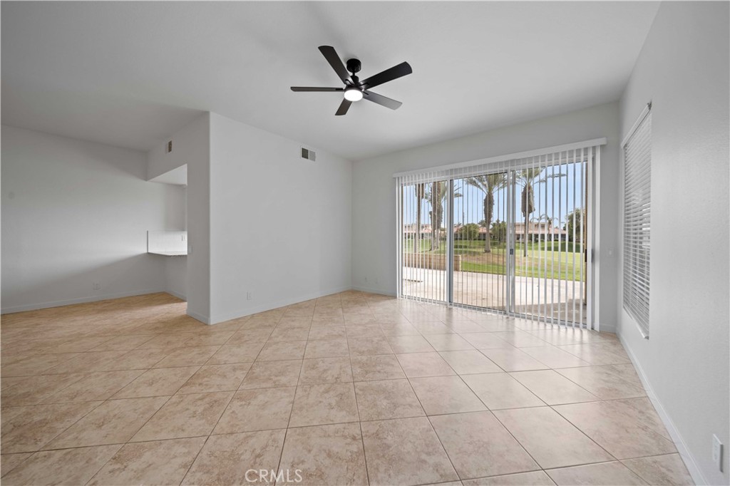 22 Oak Tree Drive Rancho Mirage, CA 92270 - Photo 4 of 25 a view of a livingroom with a ceiling fan and window