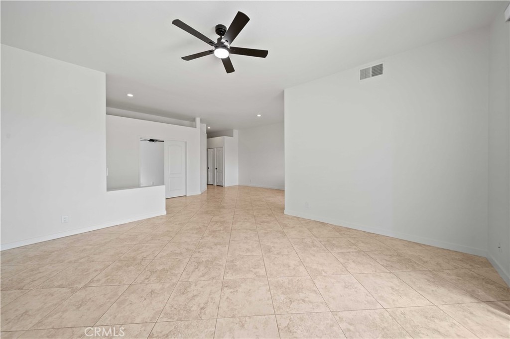 22 Oak Tree Drive Rancho Mirage, CA 92270 - Photo 5 of 25 a view of a big room with wooden floor and a ceiling fan
