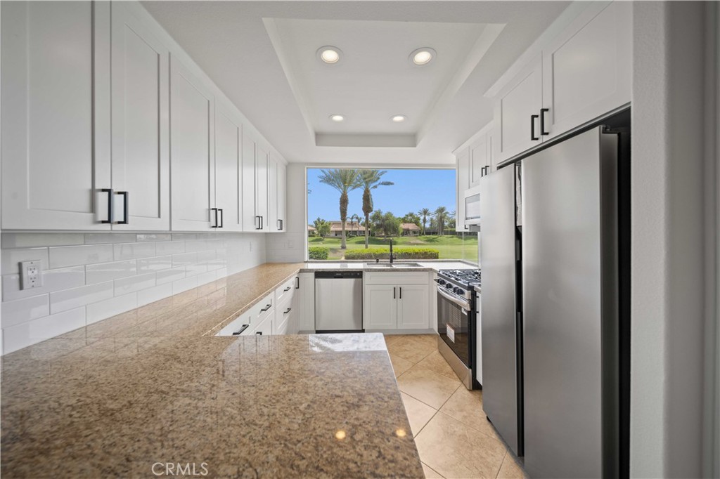 22 Oak Tree Drive Rancho Mirage, CA 92270 - Photo 6 of 25 a kitchen with refrigerator and cabinets