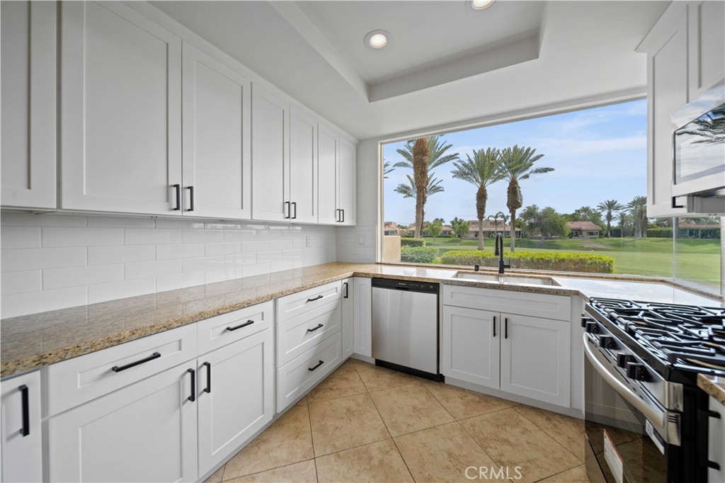 22 Oak Tree Drive Rancho Mirage, CA 92270 - Photo 7 of 25 a kitchen with a stove a sink and a cabinets