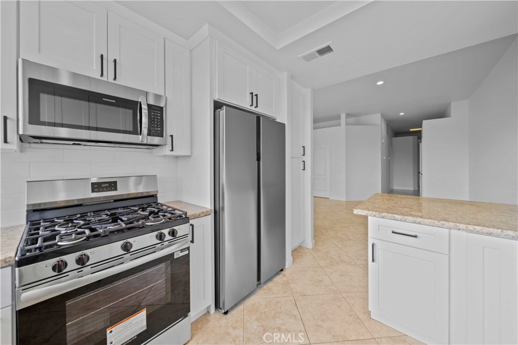 22 Oak Tree Drive Rancho Mirage, CA 92270 - Photo 8 of 25 a kitchen with cabinets and steel stainless steel appliances