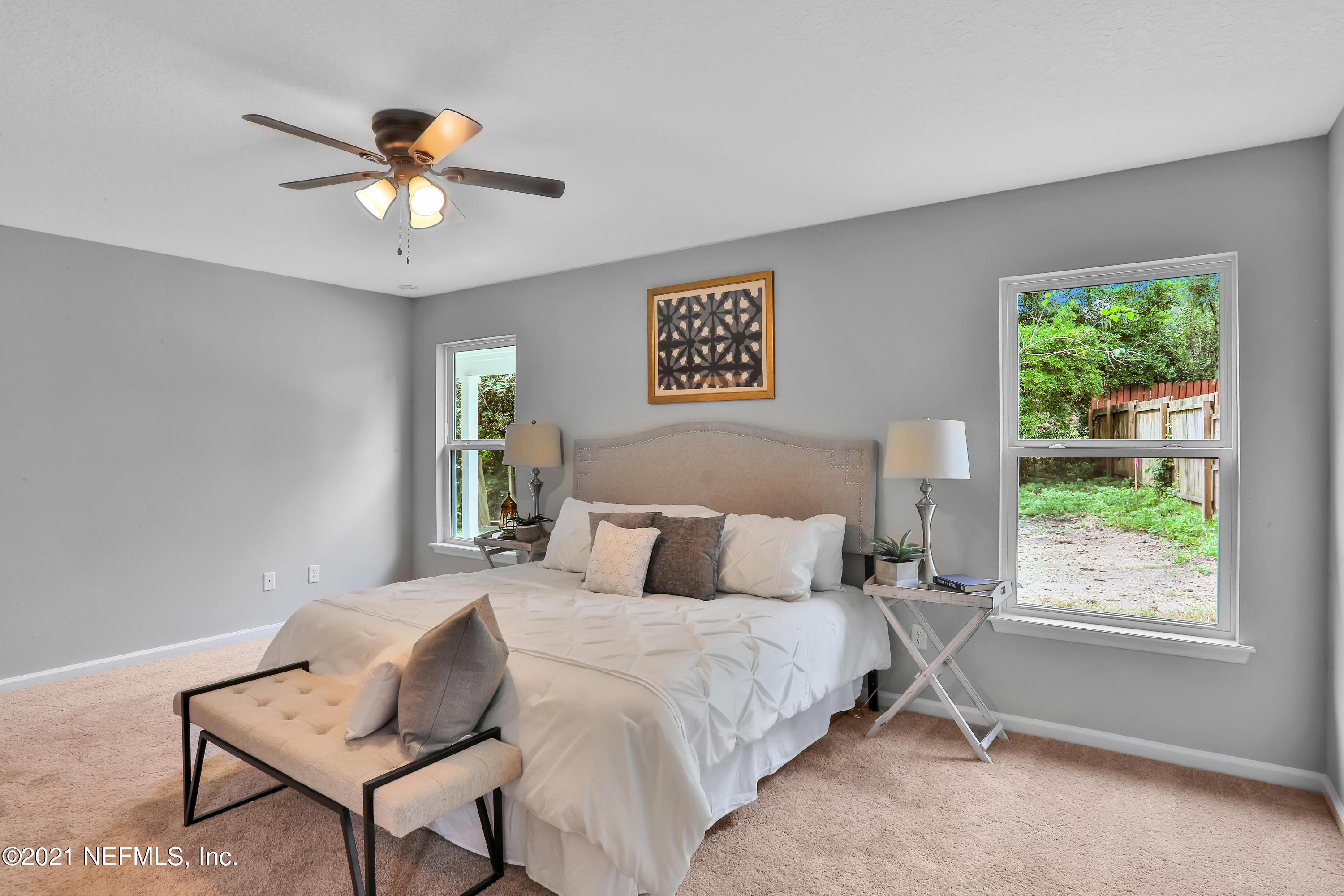 6442 Heidi Road Jacksonville, FL 32277 - Photo 12 of 30 a bedroom with a bed and a chandelier