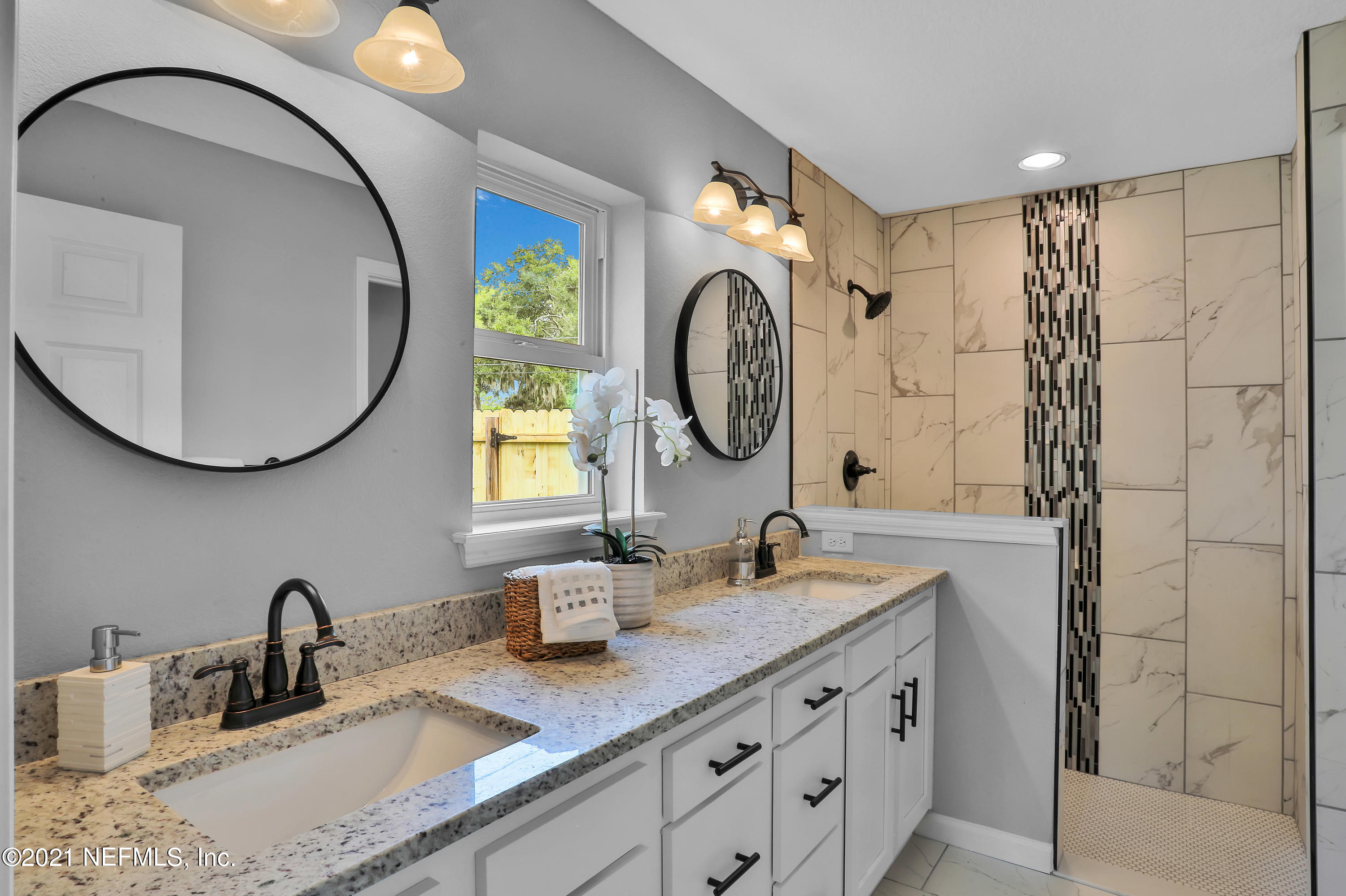 6442 Heidi Road Jacksonville, FL 32277 - Photo 15 of 30 a bathroom with a double vanity sink and a mirror