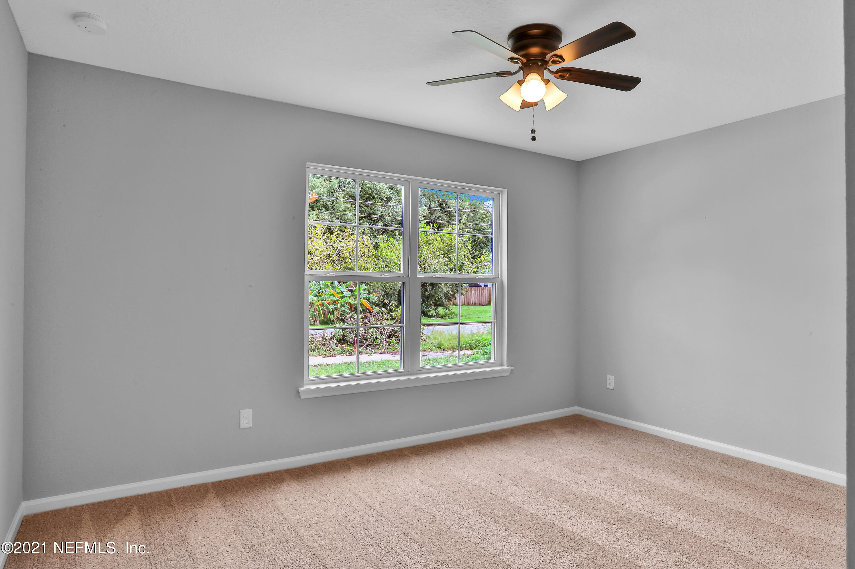 6442 Heidi Road Jacksonville, FL 32277 - Photo 18 of 30 a view of a room with a window and a fan