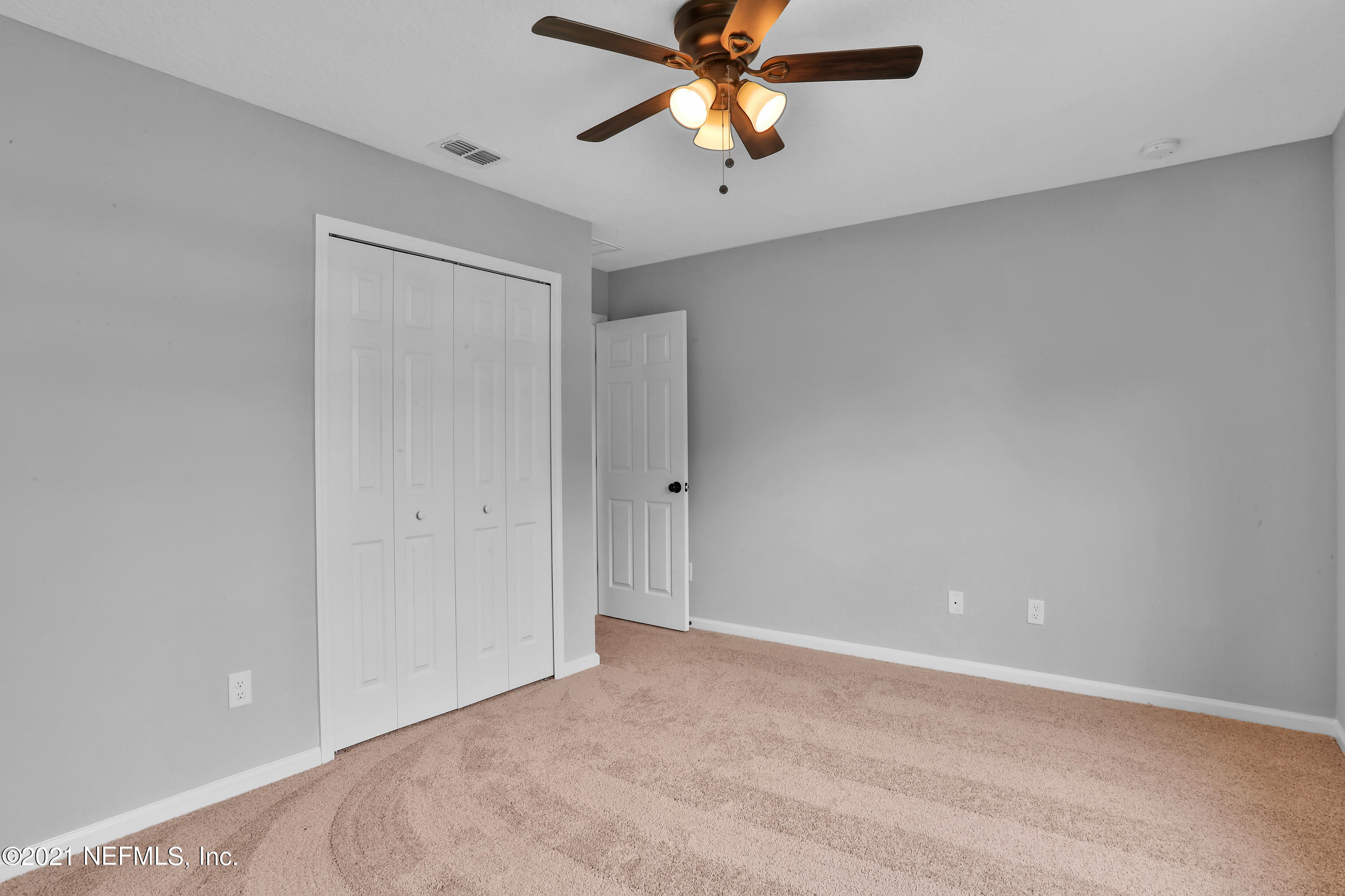 6442 Heidi Road Jacksonville, FL 32277 - Photo 19 of 30 a view of a room with a ceiling fan and wooden floor