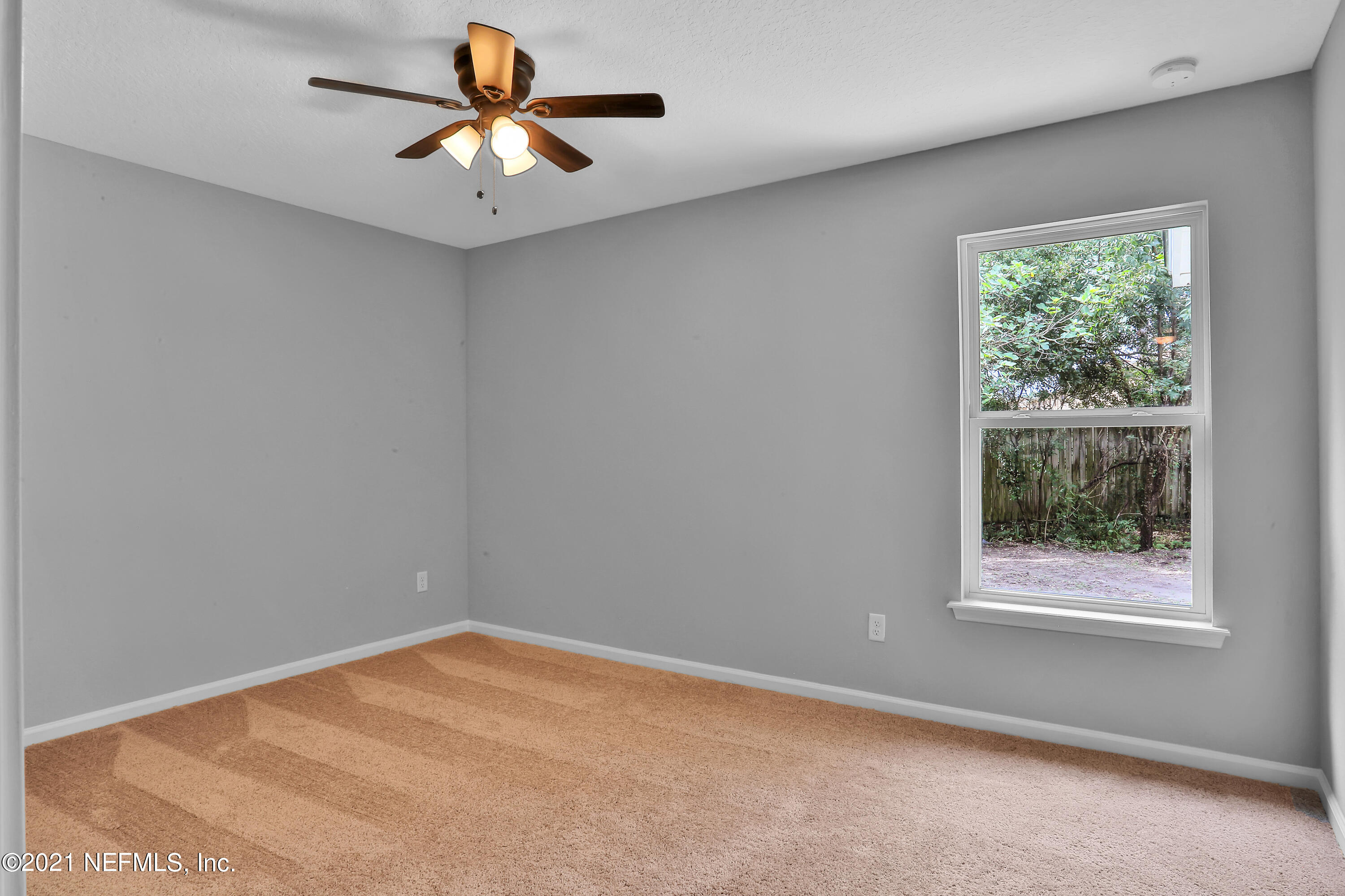 6442 Heidi Road Jacksonville, FL 32277 - Photo 20 of 30 a view of a room with a window and a ceiling fan