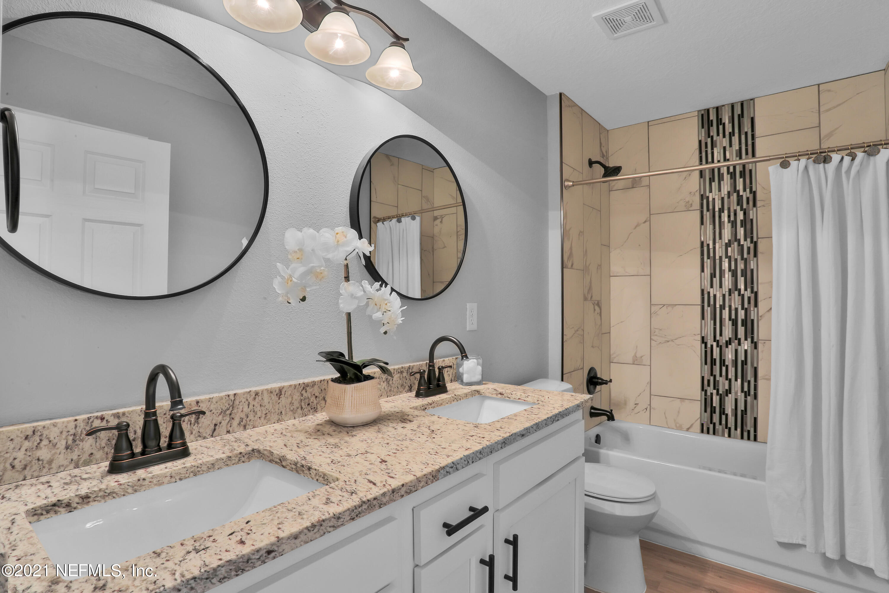 6442 Heidi Road Jacksonville, FL 32277 - Photo 23 of 30 a bathroom with a granite countertop double vanity sink and a mirror