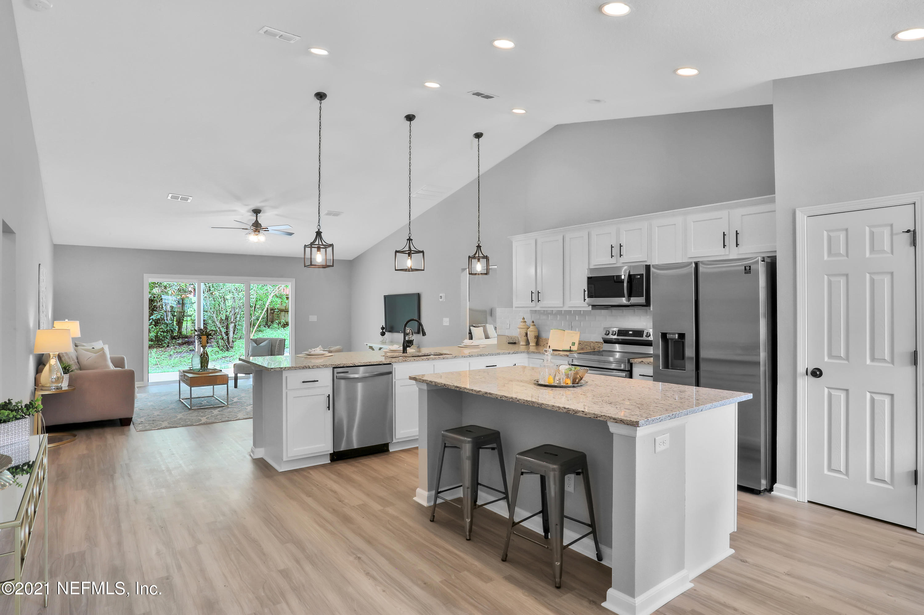 6442 Heidi Road Jacksonville, FL 32277 - Photo 3 of 30 a kitchen with stainless steel appliances a stove a sink a refrigerator a center island and couches