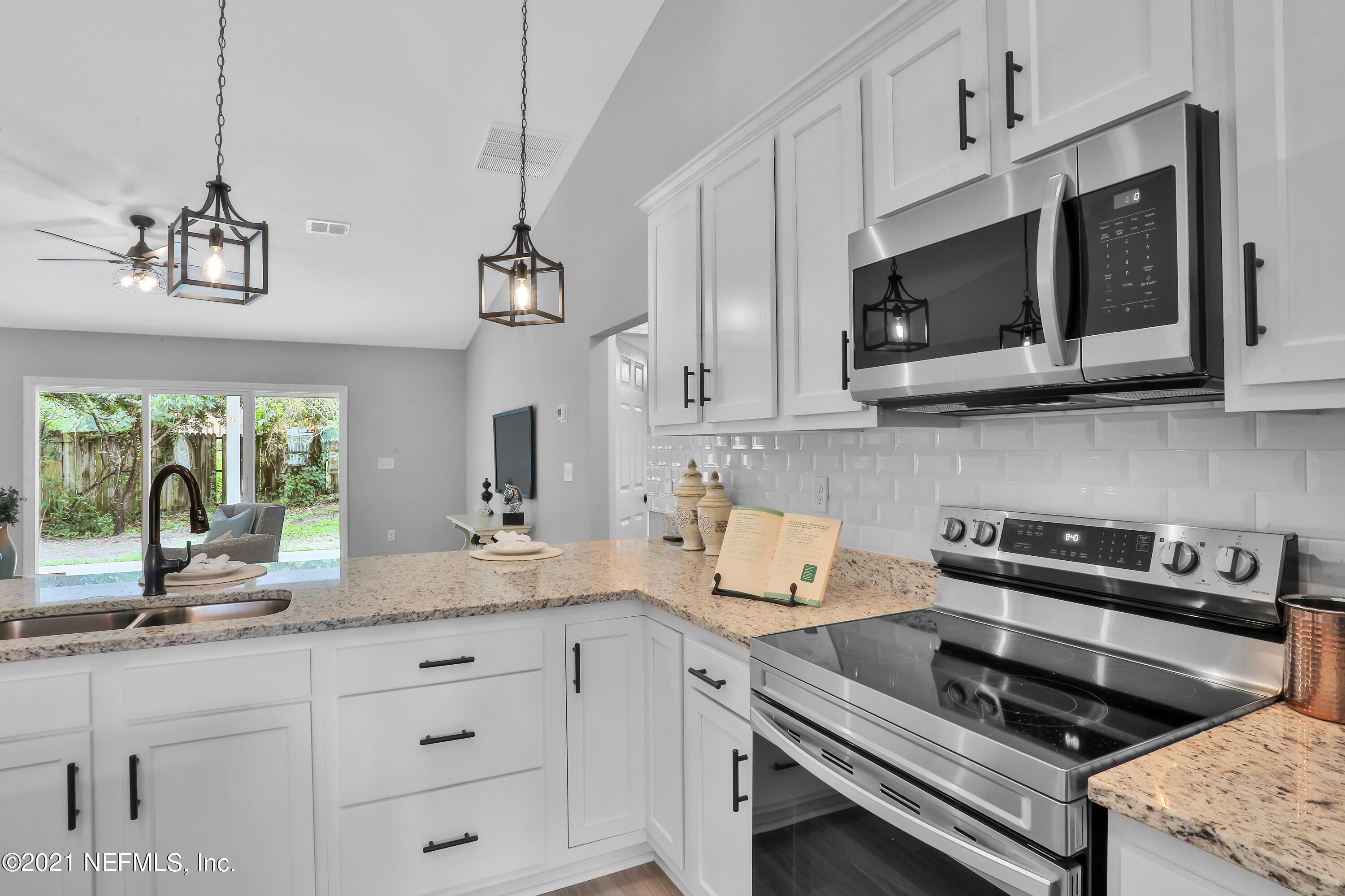 6442 Heidi Road Jacksonville, FL 32277 - Photo 4 of 30 a kitchen with appliances a sink and a microwave