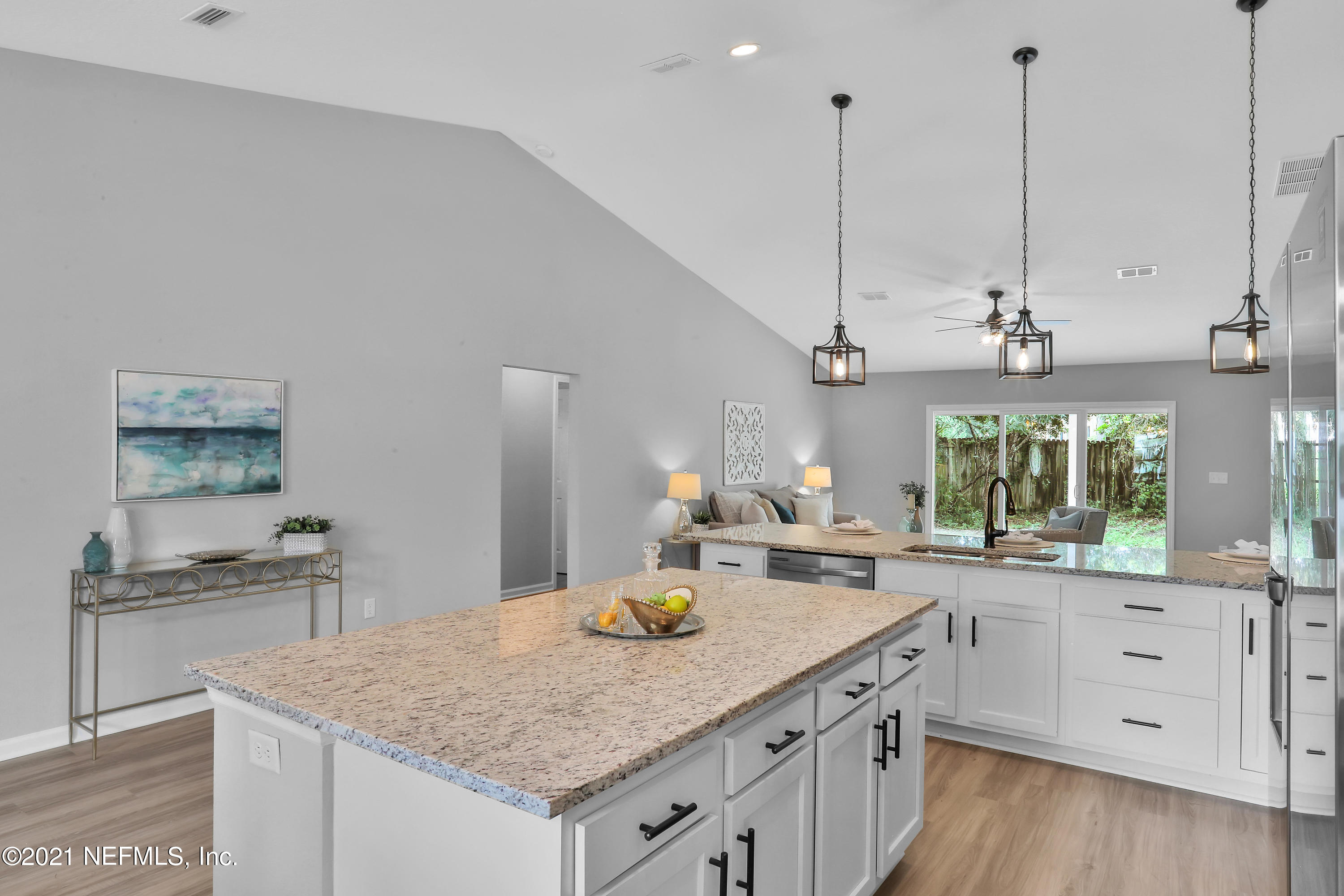 6442 Heidi Road Jacksonville, FL 32277 - Photo 8 of 30 a kitchen with a stove a sink and a wooden floor