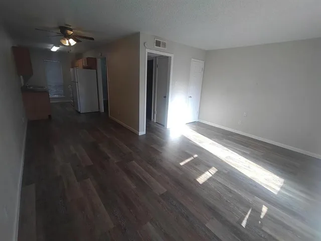 a view of hallway with wooden floor