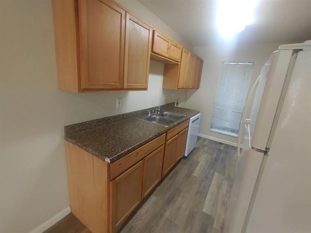 7816 Romney Road, Unit 3 Fort Worth, TX 76134 - Photo 9 of 18 a kitchen with stainless steel appliances granite countertop a sink stove and refrigerator