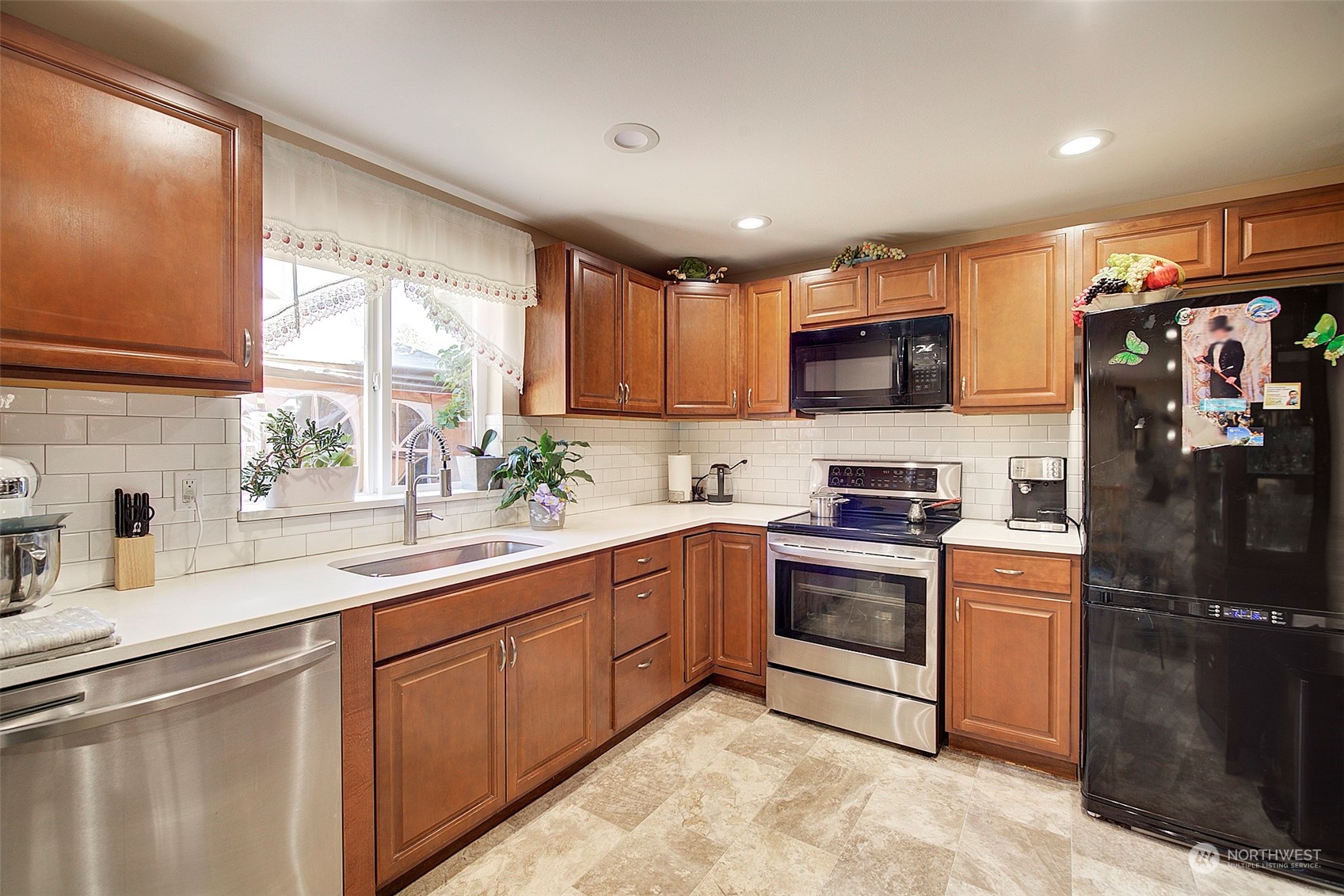 11717 2nd Drive Southeast, Unit A & B Everett, WA 98208 - Photo 17 of 40 a kitchen with stainless steel appliances granite countertop a sink a stove a refrigerator cabinets and a window