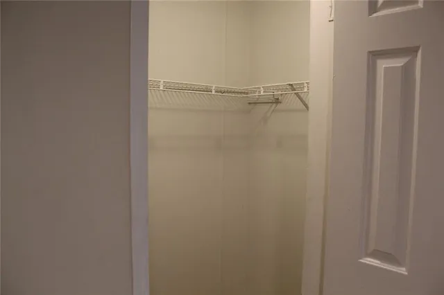 a white toilet sitting next to a shower