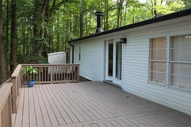 a view of a wooden fence and trees