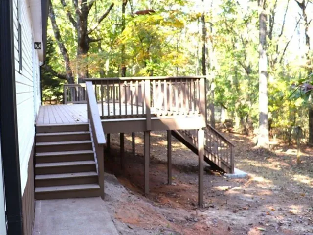a view of balcony with wooden floor and outdoor seating
