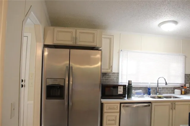 a kitchen with a sink stove and refrigerator