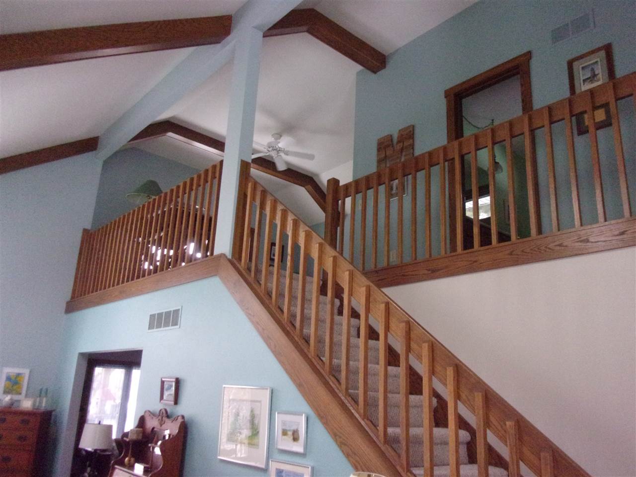 3745 Freeport Road Rockton, IL 61072 - Photo 15 of 24 a view of staircase with lots of frames on wall and wooden floor