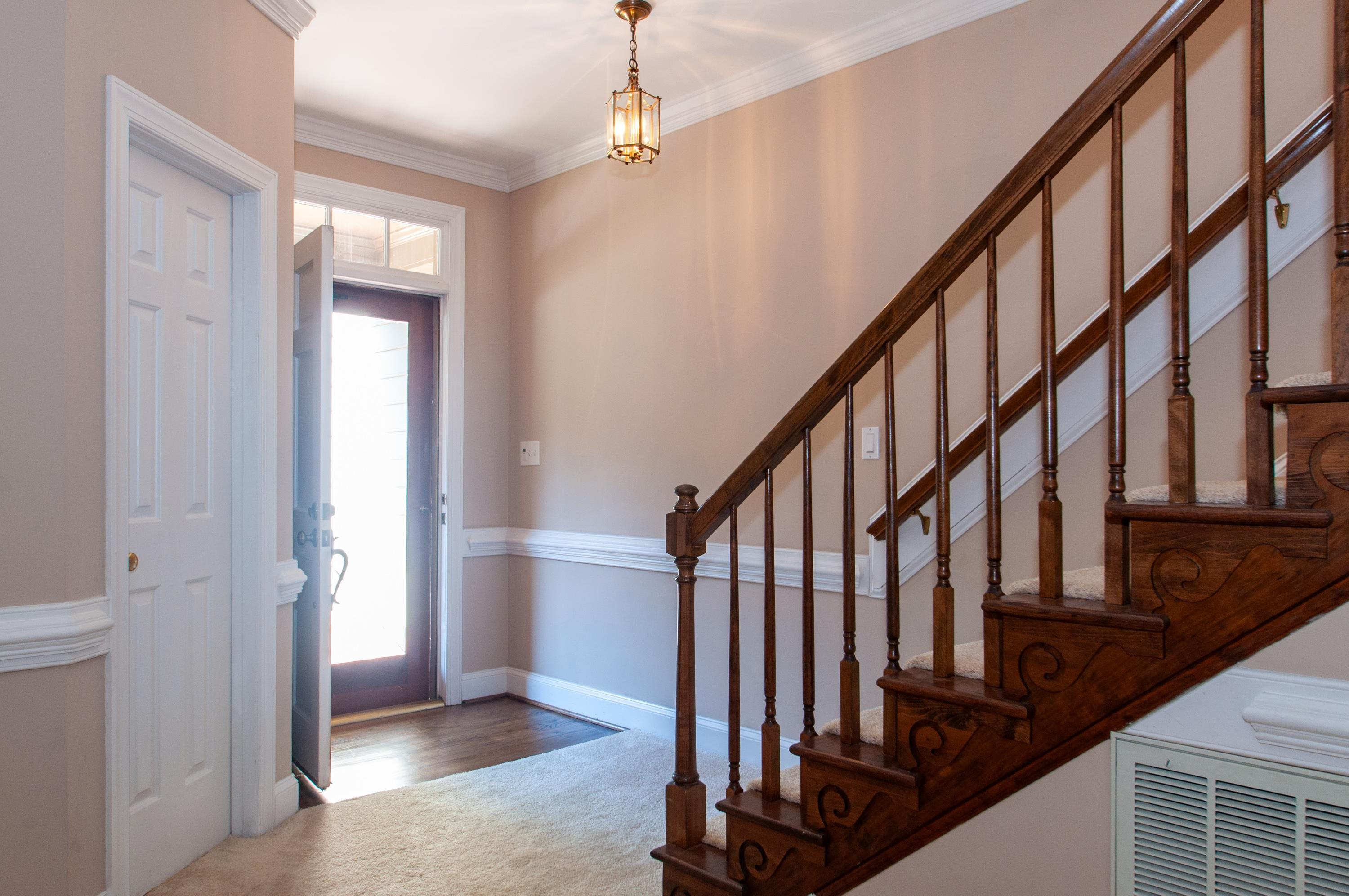 7914 Footman Way Raleigh, NC 27615 - Photo 23 of 38 a view of an entryway with wooden floor and door