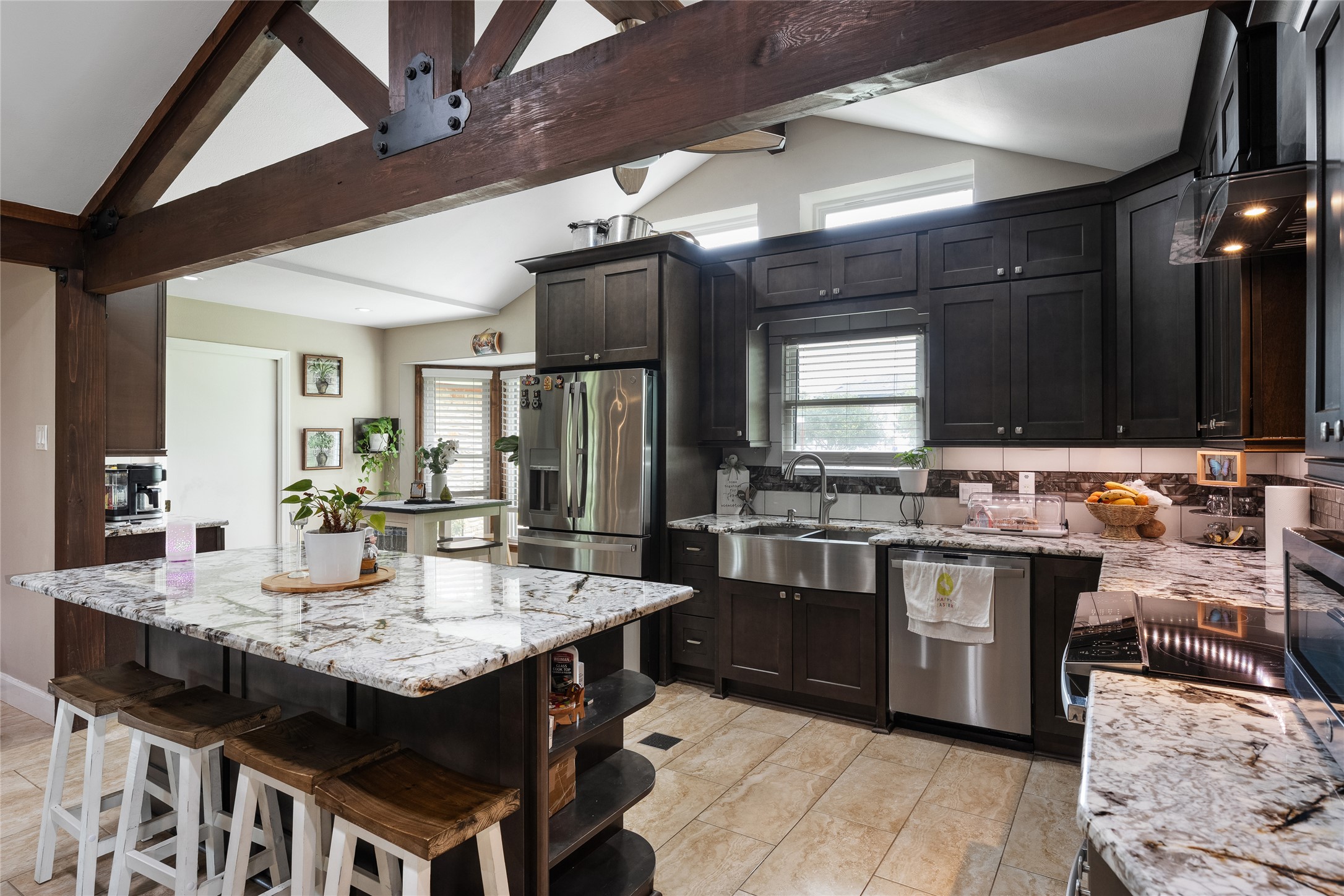 301 Oak Ridge Road Georgetown, TX 78628 - Photo 7 of 34 Kitchen featuring exposed wood beams, vaulted ceilings, and a large central island with seating