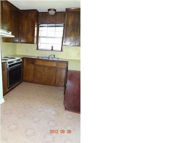 6184 Old Hickory Road Crestview, FL 32539 - Photo 6 of 14 a kitchen with granite countertop a sink and a stove