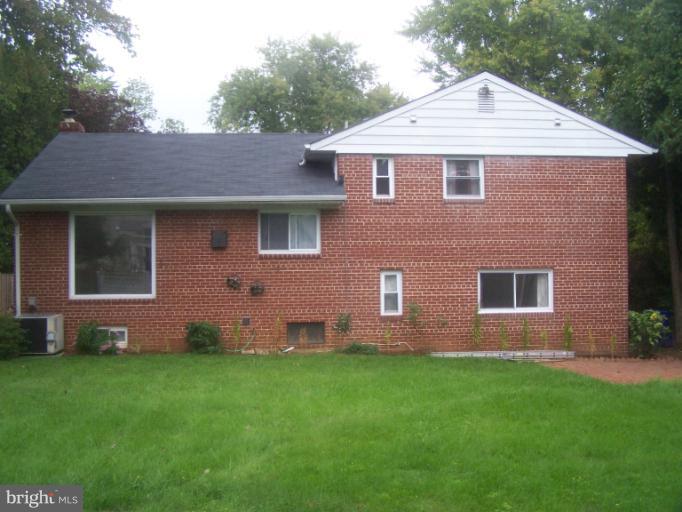 6002 Greentree Road Bethesda, MD 20817 - Photo 1 of 14 a front view of a house with a garden