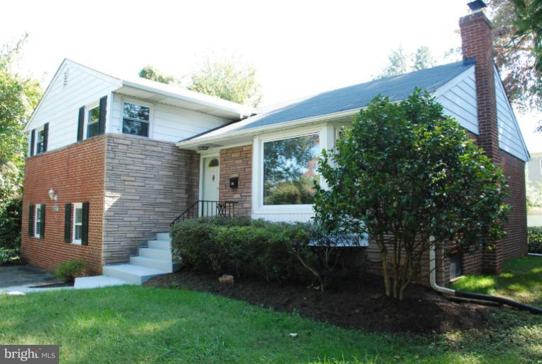 6002 Greentree Road Bethesda, MD 20817 - Photo 2 of 14 a front view of a house with garden