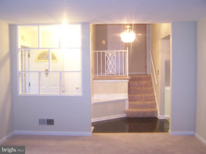 6002 Greentree Road Bethesda, MD 20817 - Photo 8 of 14 an entryway with a window and wooden floor
