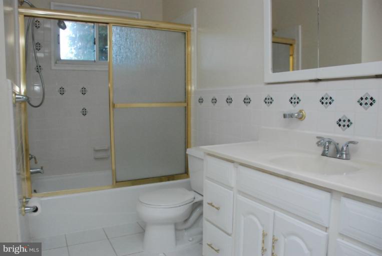 6002 Greentree Road Bethesda, MD 20817 - Photo 9 of 14 a bathroom with a sink a toilet and shower