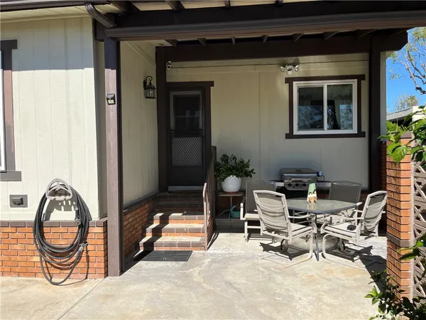 a view of backyard with a table and chairs