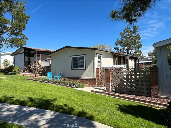 a view of house with a yard