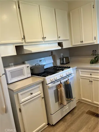 a stove top oven sitting inside of a kitchen