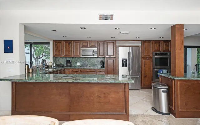 a bedroom with a large bed and a large window