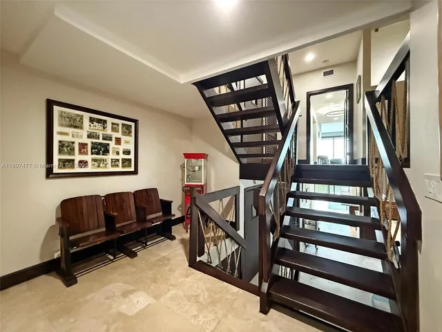 a bathroom with a granite countertop double vanity sink and a mirror