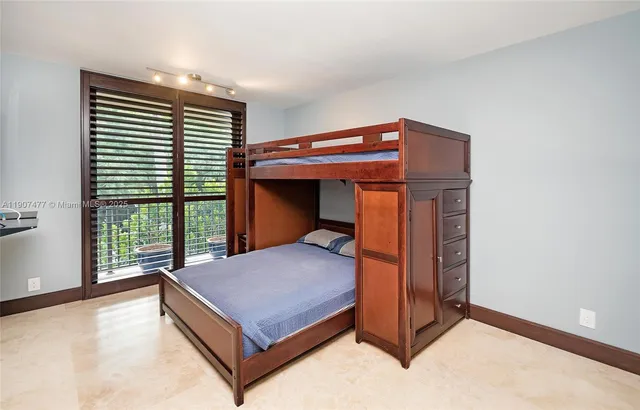 a large kitchen with kitchen island granite countertop a sink and cabinets