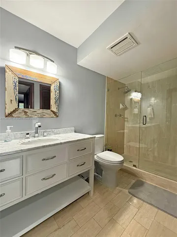 a bathroom with a sink toilet and mirror