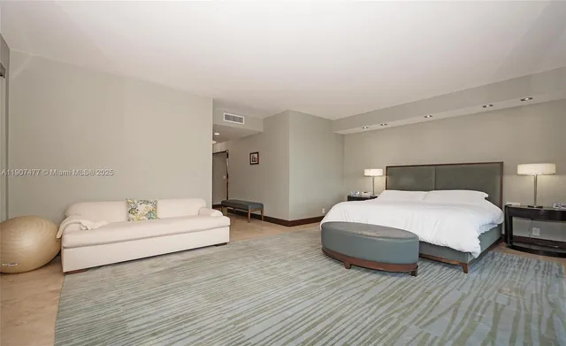 a living room with furniture a flat screen tv and kitchen view