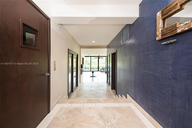 a view of entryway and hall with wooden floor