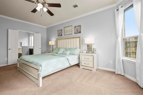 a spacious bedroom with a bed and a chandelier