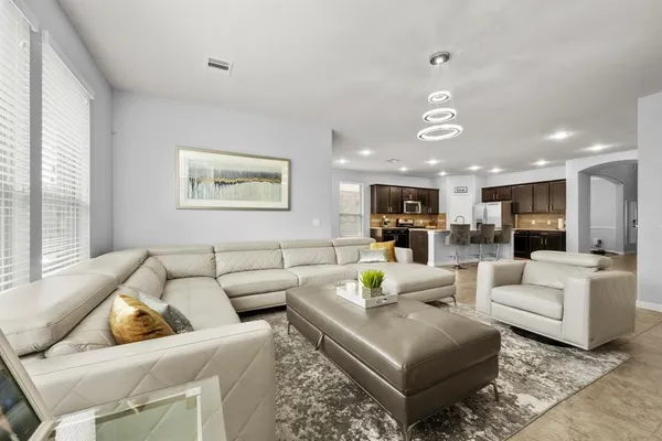 a living room with furniture and a large window