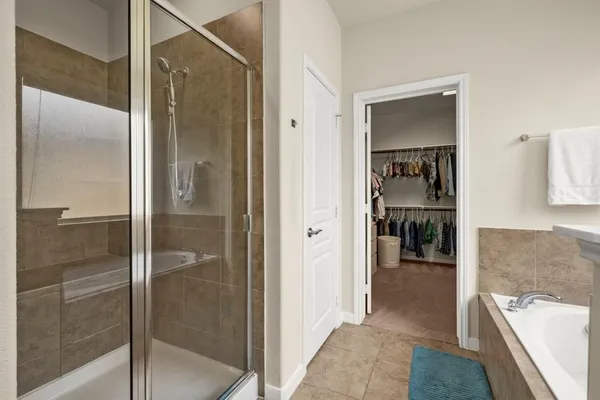 a bathroom with a tub and shower